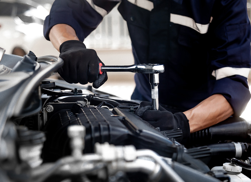GMC Maintenance Specialist working on engine of SUV