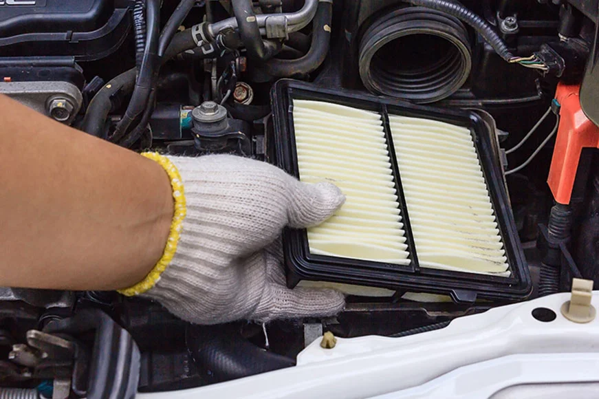SUV Air filter being replaced by a GMC Maintenance specialist