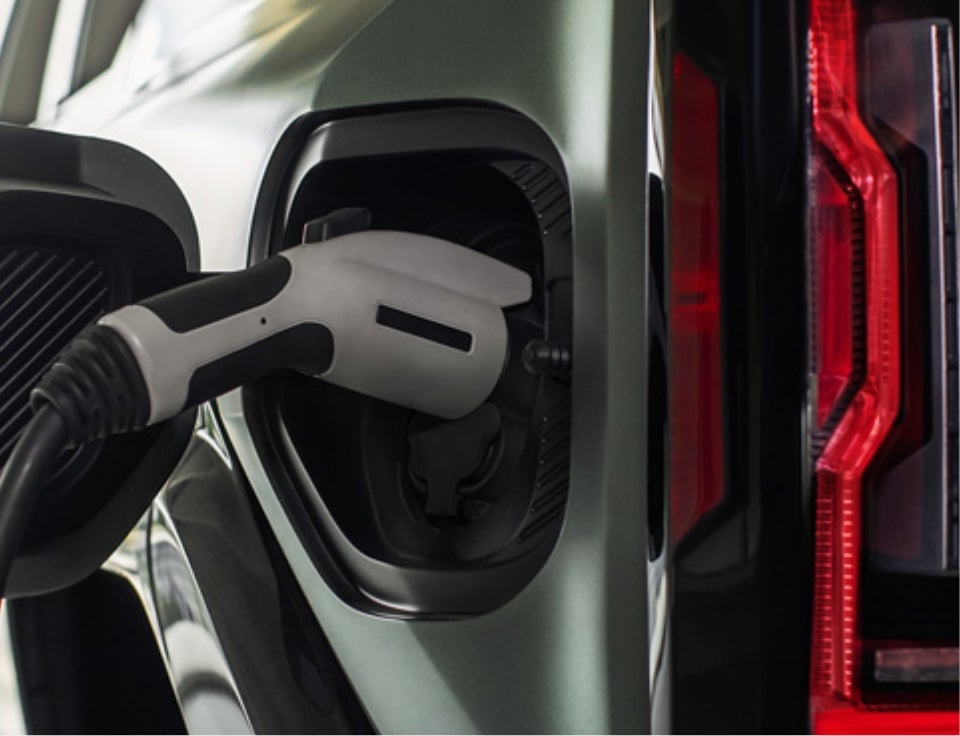 Close up of charging port with charger plugged in on a GMC Hummer EV SUV - Gross GMC of Black River Falls in Black River Falls WI