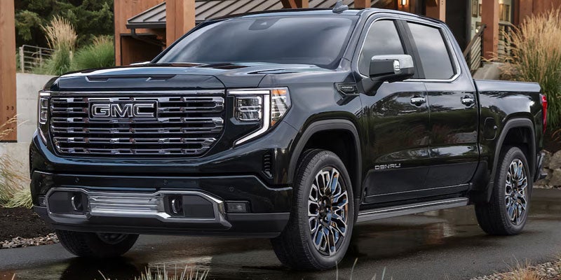 2026 GMC Sierra 1500 parked outside showcasing bold grille and premium styling