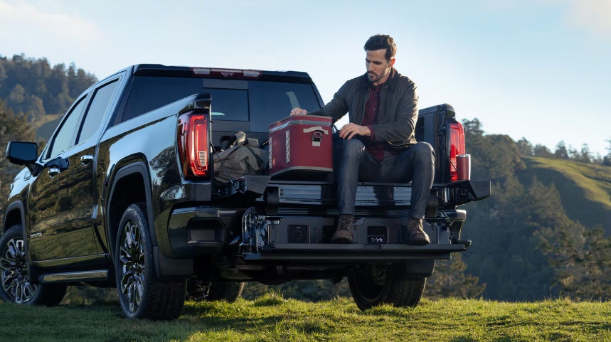 GMC Pickup truck with a man sitting in the back