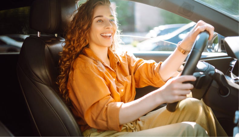 Woman driving her recently purchased vehicle